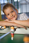 Portrait of a boy leaning on a foosball table - AJMN9W