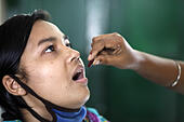 Dhaka, Bangladesh. 24th Mar, 2014. Sonia taking TB medicine.Sonia age - E6GBXD